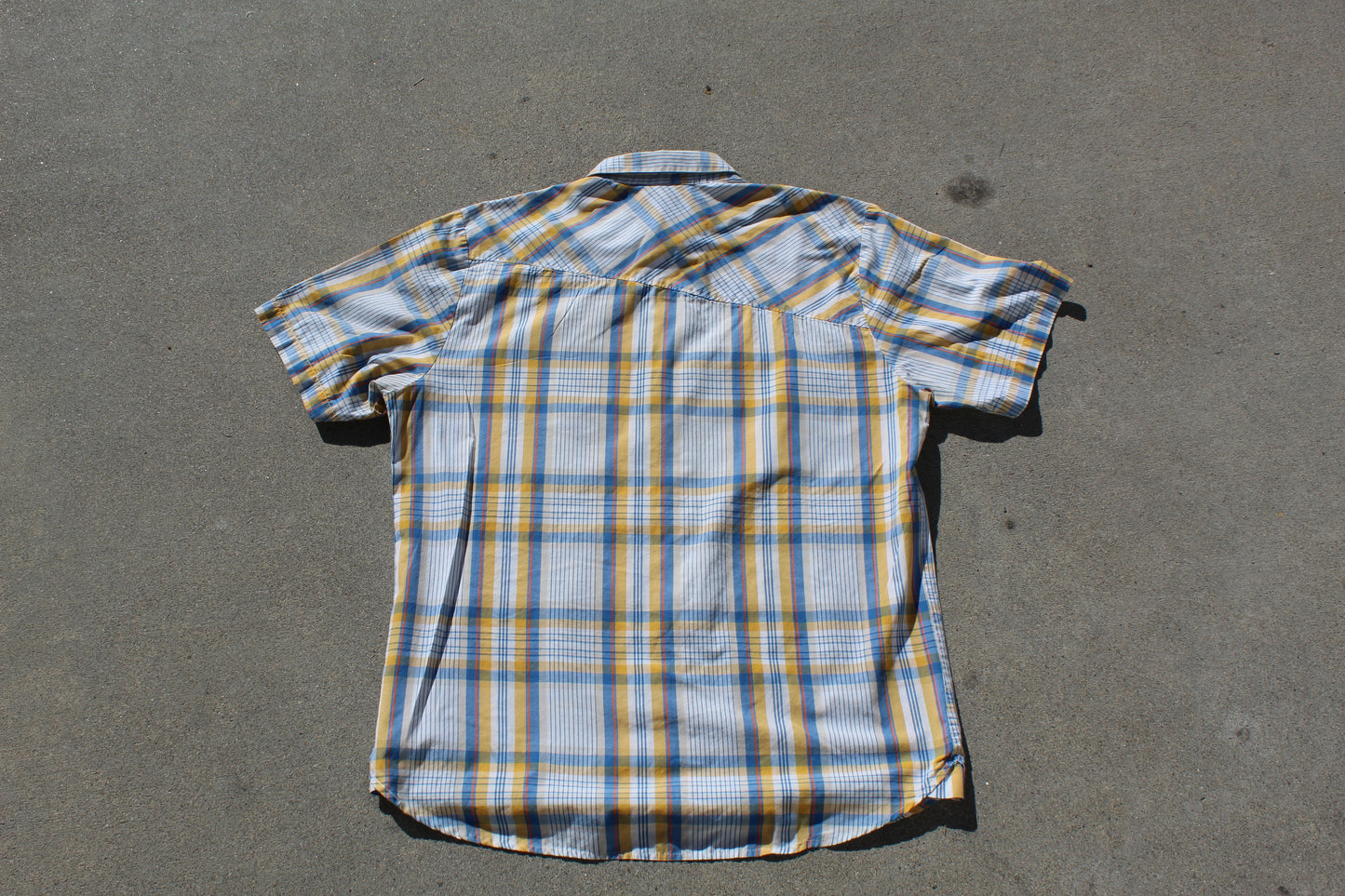 Plaid shirt on a gray surface

